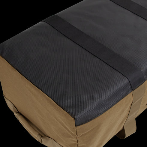 A close-up view of the Condor Colossus Duffle Bag 60L, featuring a rectangular shape, black top, brown sides, and two black straps running across the top.